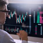 Crypto trader investor using computer analyzing cryptocurrency stock market.