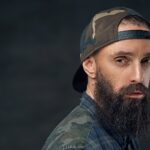 Bearded male in military cap.