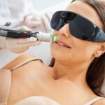 Woman wearing safety goggles during a facial hair removal