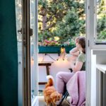 Young woman is relaxing at balcony