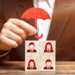 The businessman insures and protects the business team of employees. Team insurance, protection. Provision of an extensive range of solutions tailored to protect assets. Government business support.